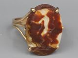 an image of a ring with a brown and white stone