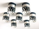 six tasses à pois noirs et blancs suspendues au plafond
