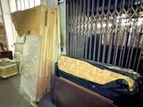 a bed that is sitting in a room with a fence
