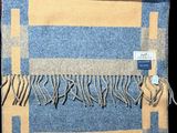 blue and yellow checkered wool scarf with fringes on a black background