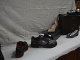 several pairs of shoes are lined up on a table in front of a white backdrop