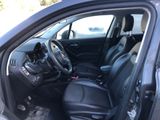 the interior of a car with the door open and the driver ' s seat down