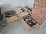 boxes of shoes sitting on the floor next to a chair