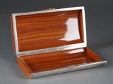 a small wooden box with a metal handle on a table