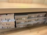 many boxes that are stacked up on the shelf
