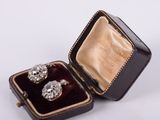 an image of a pair of diamond earrings in a velvet box