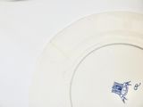 a white plate with a blue bird on it on a table