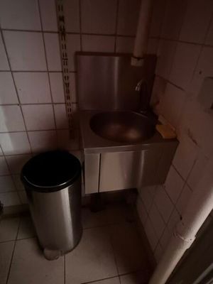 une poubelle et une poubelle dans une petite salle de bains