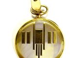 an image of a gold pocket watch with a piano keyboard on it