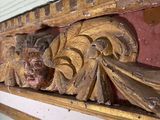 a close up of a decorative piece of wood on a wall