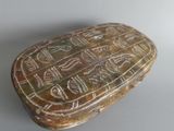 an image of a stone box with writing on it on a table