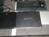 two laptops and a keyboard sitting on a table