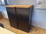 a black refrigerator with a wooden top in a room