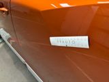 a sticker on the door of an orange car