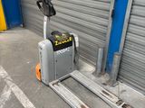 a fork lift truck parked in front of a garage door