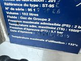 a blue sign on the side of a machine