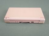 a pink laptop sitting on a table with its lid open