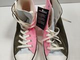 pair of pink and green converses with white laces on a white surface