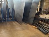 several pieces of metal are stacked on top of each other in a warehouse