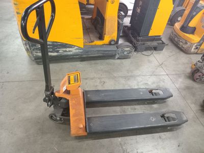 a picture of a forklift in a warehouse with other equipment