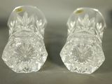 pair of clear glass salt and pepper shakers sitting on top of a table