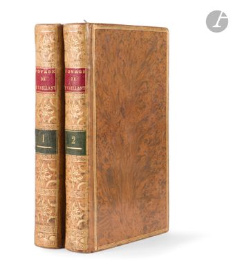 an old book sitting on top of a wooden book case
