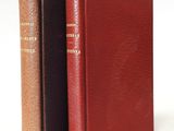 two books sitting next to each other on a white surface