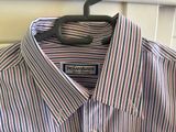 striped shirt hanging on a hanger in front of a window