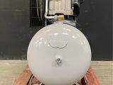 an air compressor sitting on a pallet in front of a wall