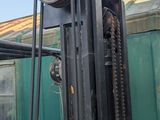 a fork lift truck that is parked next to a building