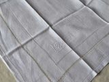 a white table cloth with a design on it on a table