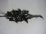 a metal object that has a bunch of flowers on it