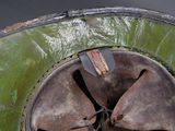 a close up of a metal object with a piece of wood sticking out of it