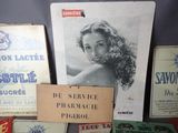 some old advertising items are displayed on a table in a room