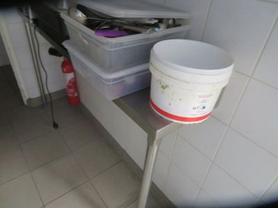 a bucket sitting on top of a table in a kitchen