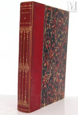 an old book sitting on top of a table next to a white wall