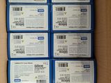 several boxes of blue and white coups in a cardboard box