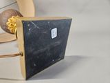 a picture of a black and gold purse on a white table