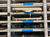 many pallets of wood in a warehouse with blue tape on them