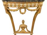 a gold console table with a black marble top