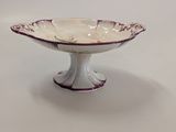 a white and purple bowl on a white table