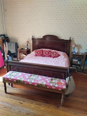 a bed and a bench in a room with wood floors