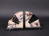 pair of black and white marble bookends on black background