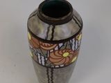 a vase with a design on it on a white surface