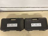 pair of black cases sitting on the floor next to each other