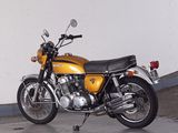 a yellow motorcycle parked in a parking garage
