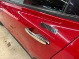 a close up of a car door handle with a sticker on it