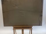 an easel with a painting on it and a white background