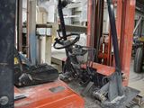 a forklift in the middle of a room with other equipment