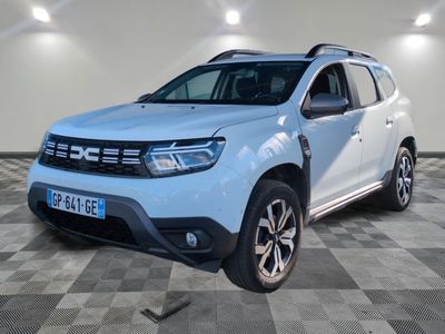 vue de face d'une Dacia blanche garée sur un sol à damier